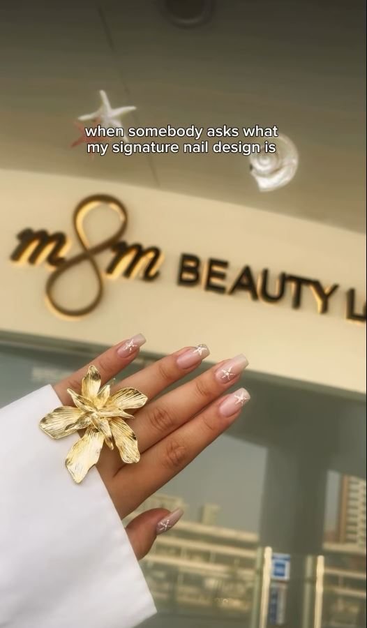 A finished set held up beneath the M&M Beauty Lounge sign